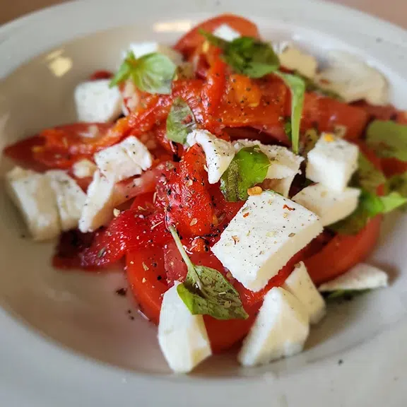 Fresh tomato and feta cheese salad with basil